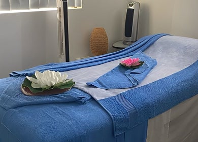Tranquil massage table setup at Tran Spa and Massage in Stretton, Queensland, AU, with calming blue tones.