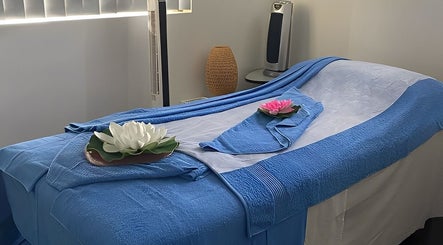 Tranquil massage table setup at Tran Spa and Massage in Stretton, Queensland, AU, with calming blue tones.