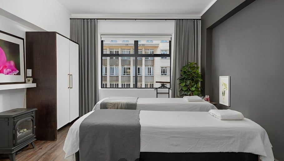 Relaxing massage room at More Massage in Cape Town, Western Cape, ZA with two tables and calming decor.