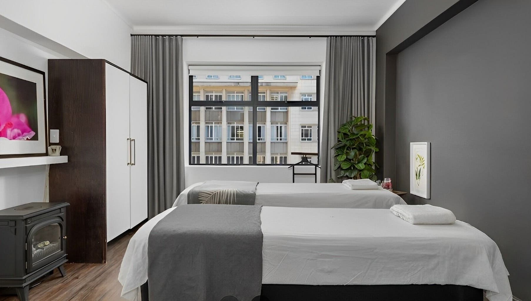 Relaxing massage room at More Massage in Cape Town, Western Cape, ZA with two tables and calming decor.