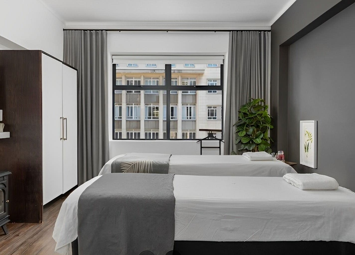 Relaxing massage room at More Massage in Cape Town, Western Cape, ZA with two tables and calming decor.