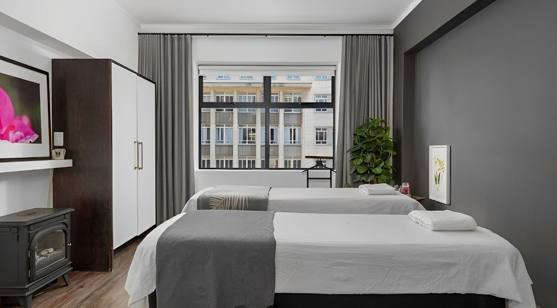 Relaxing massage room at More Massage in Cape Town, Western Cape, ZA with two tables and calming decor.