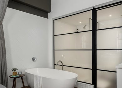 Elegant bathtub in minimalistic decor at More Massage, Cape Town, Western Cape, ZA, offering relaxation.