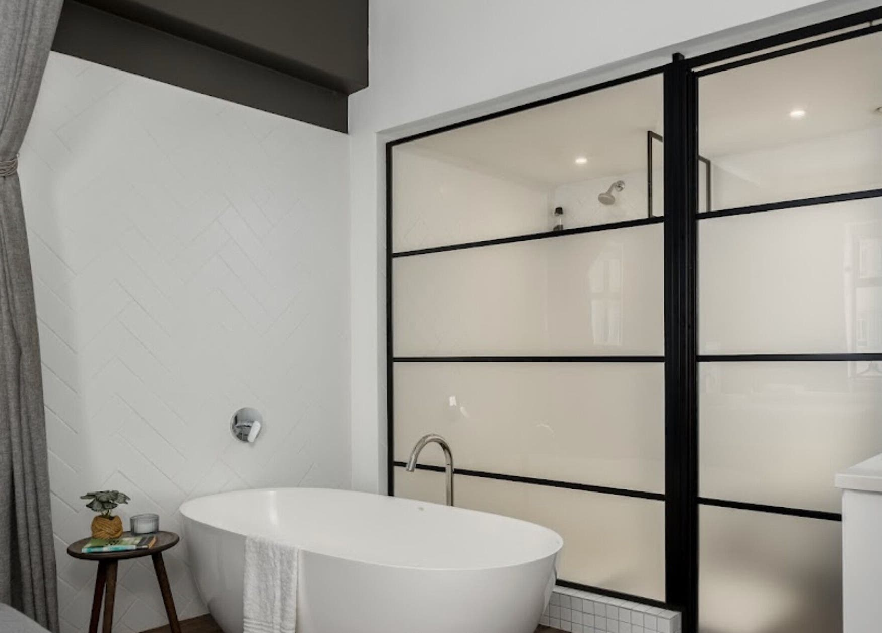Elegant bathtub in minimalistic decor at More Massage, Cape Town, Western Cape, ZA, offering relaxation.