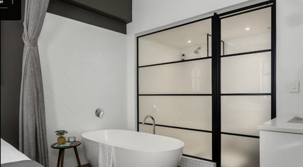 Elegant bathtub in minimalistic decor at More Massage, Cape Town, Western Cape, ZA, offering relaxation.