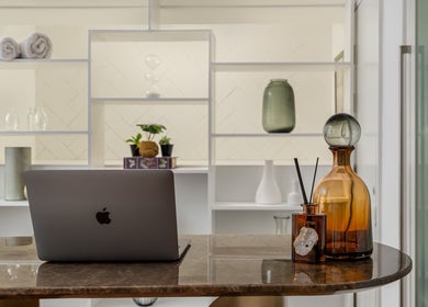 Tranquil reception area at More Massage in Cape Town, Western Cape, ZA with elegant decor and a laptop.