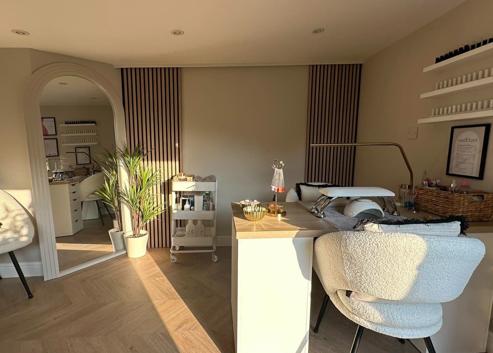 Elegant nail station at Nails by Ezme, Ashford, England, GB with stylish decor and plush seating.