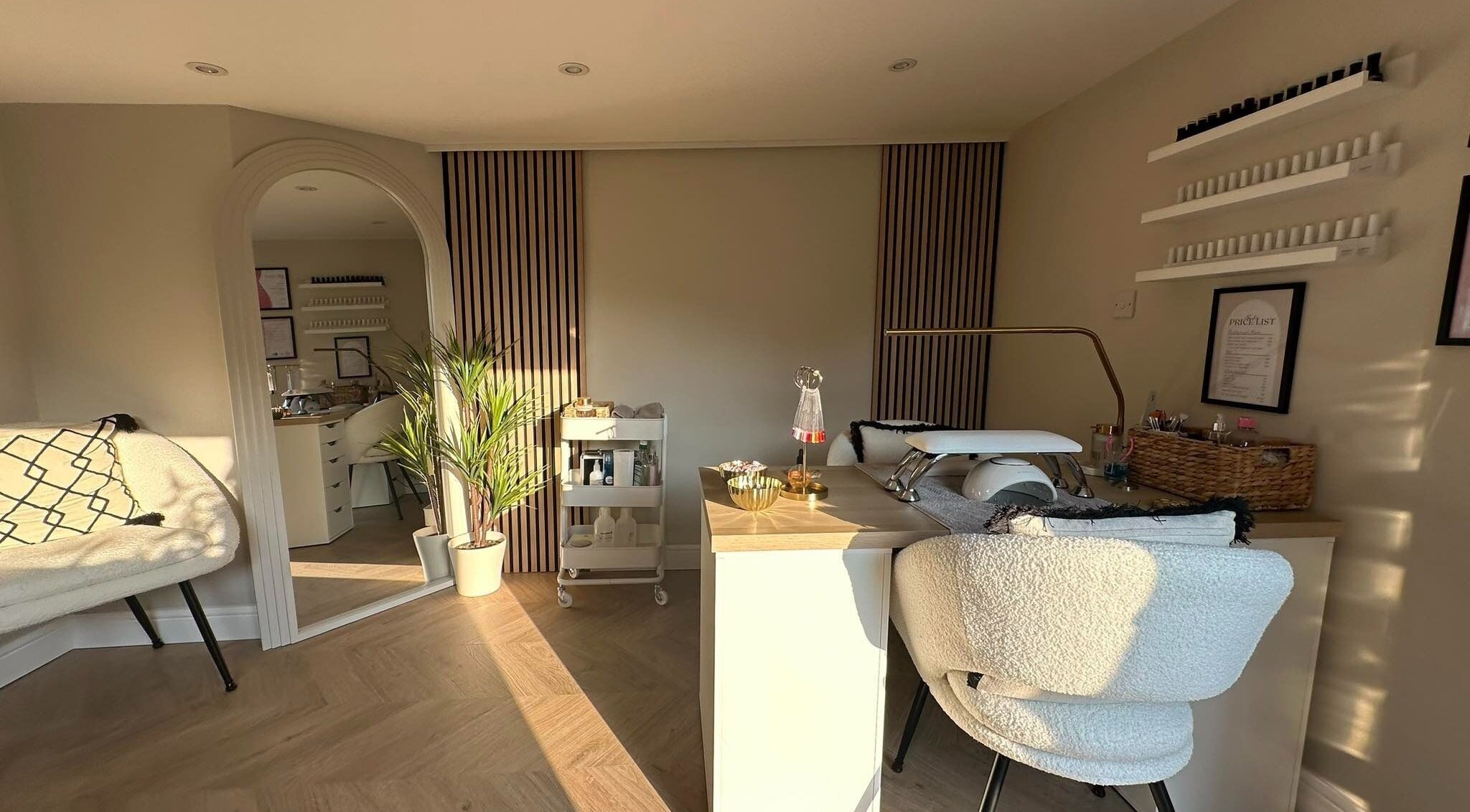 Elegant nail station at Nails by Ezme, Ashford, England, GB with stylish decor and plush seating.