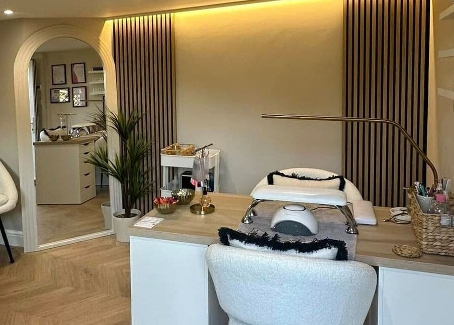 Sophisticated nail station at Nails by Ezme, Ashford, England, GB. Warm lighting and cozy seating.