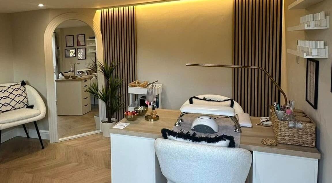 Sophisticated nail station at Nails by Ezme, Ashford, England, GB. Warm lighting and cozy seating.