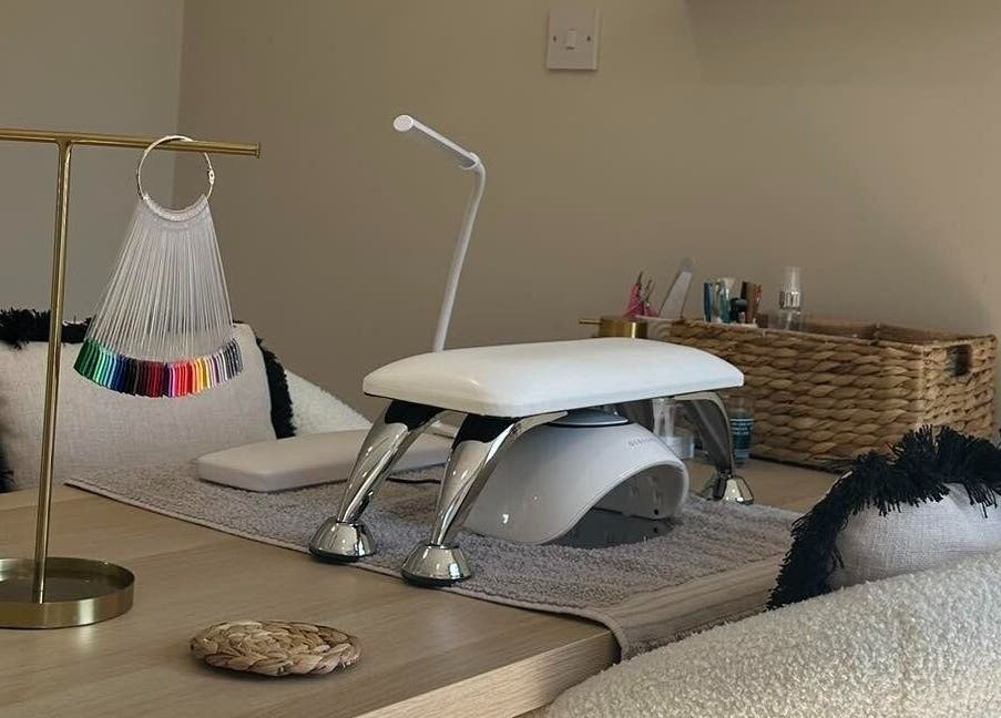 Modern nail station at Nails by Ezme in Ashford, England, GB, featuring sleek tools and colorful polish palette.