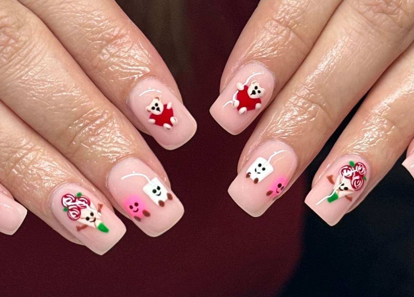 Cute nail art on manicured hands by Nails by Ezme, Ashford, England, GB.