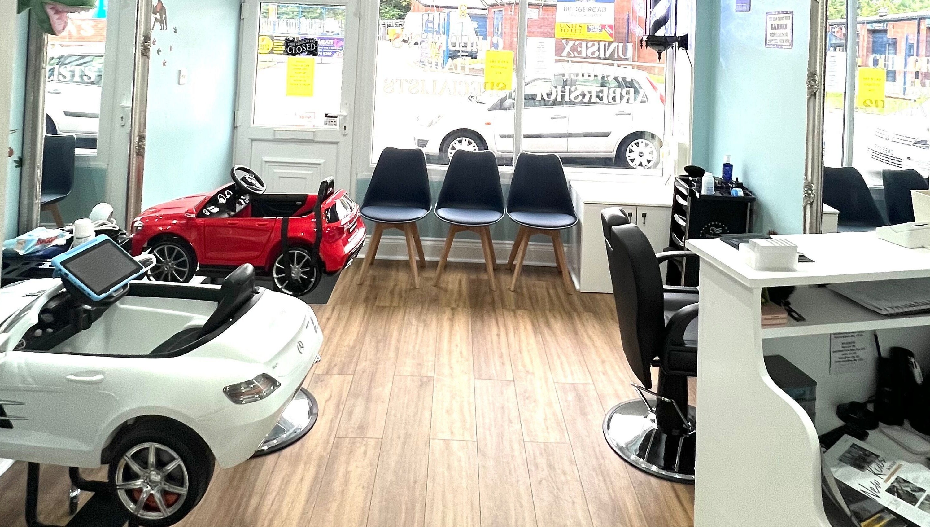 Bright chic beauty area at Scruffs, Litherland, England, GB with chairs and toy cars.