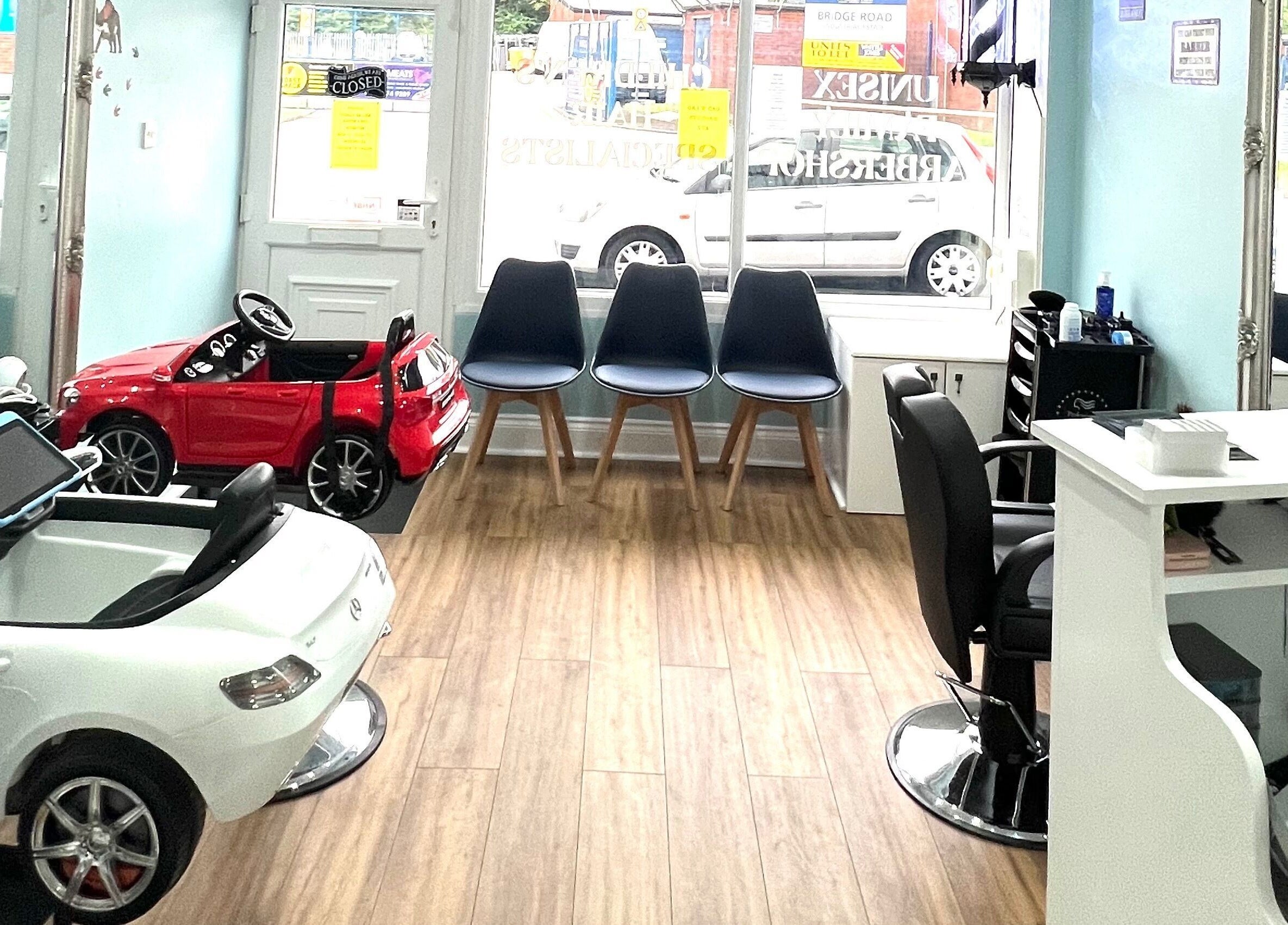 Bright chic beauty area at Scruffs, Litherland, England, GB with chairs and toy cars.