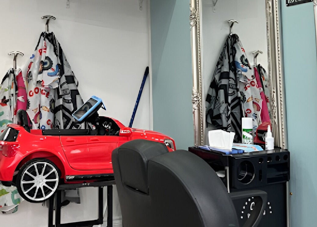 Unique kid-friendly beauty setup at Scruffs, Litherland, England, GB with red mini car chair and stylish decor.