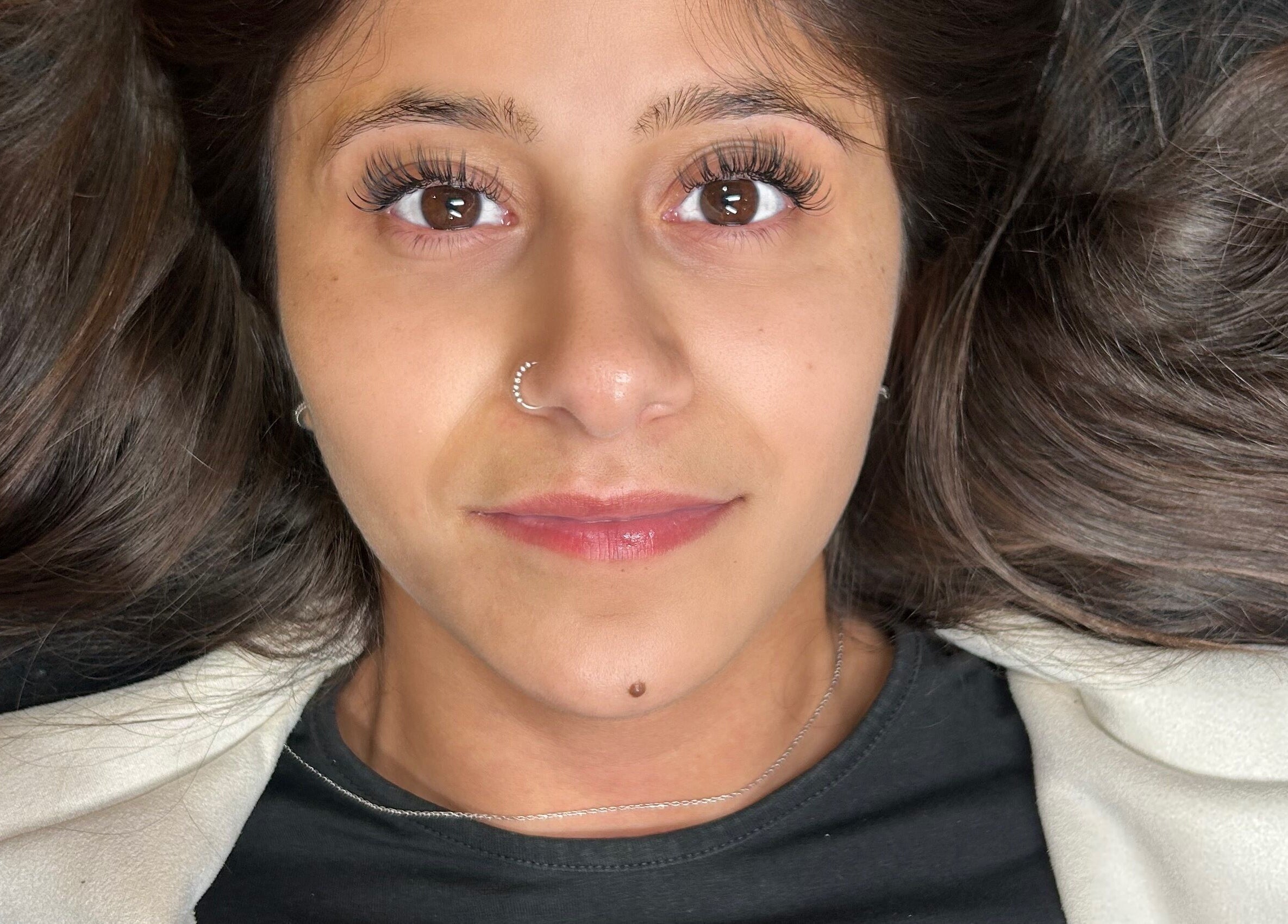 Close-up of a woman with styled hair at Mfb Beauty, Harlow, England, GB.