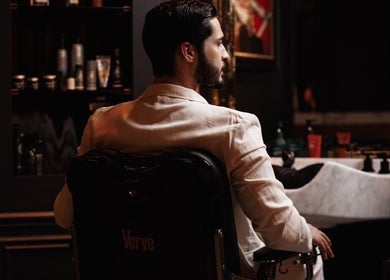Sophisticated barber chair at Verve Barbershop, Dubai, Dubai, AE, with gentleman in focus.