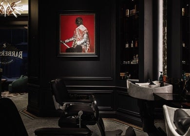 Chic interior of Verve Barbershop in Dubai, Dubai, AE with classic black decor and vintage barber chair.