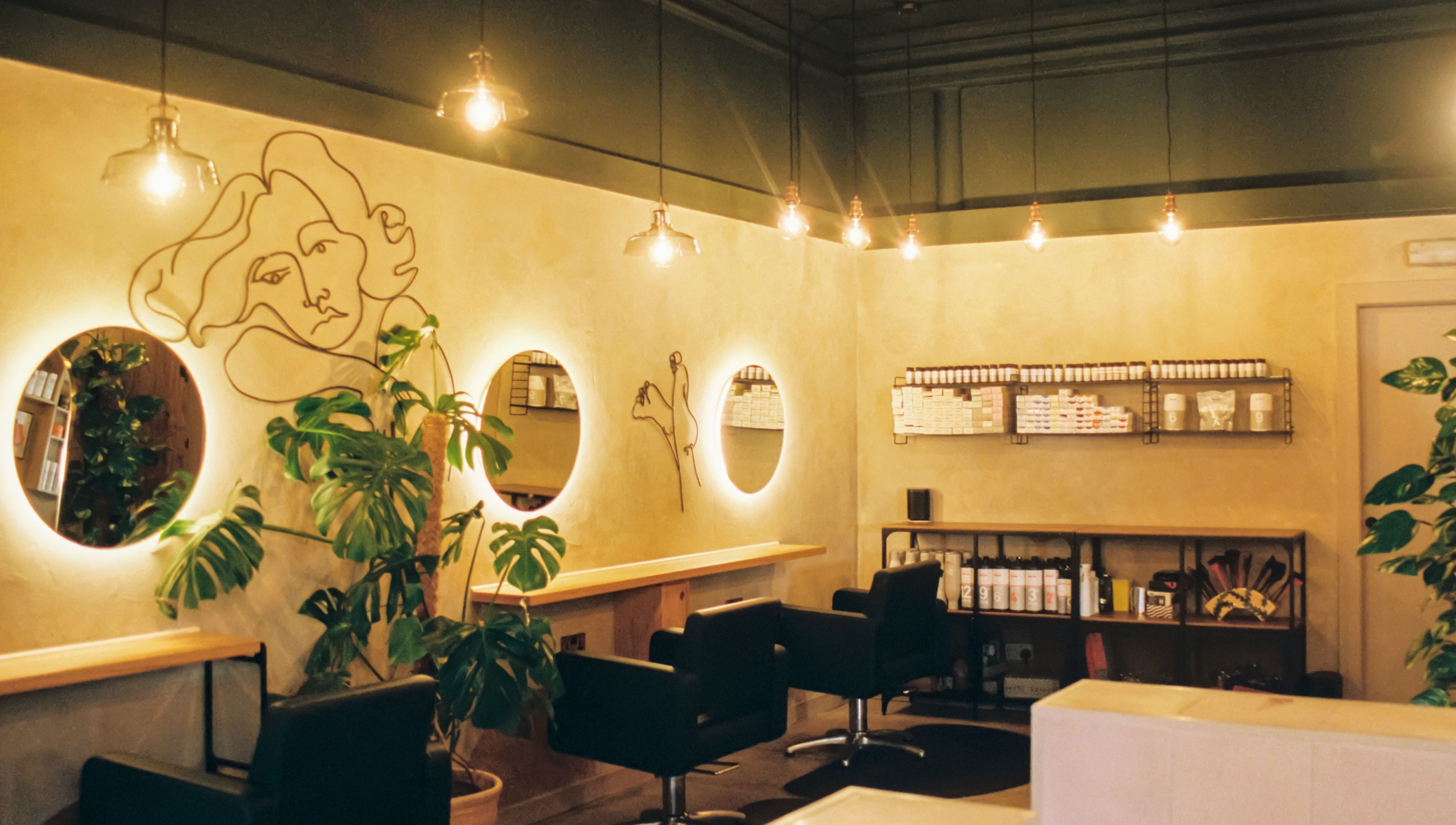 Stylish salon interior with illuminated mirrors at Cùrlach, Glasgow, Scotland, GB.