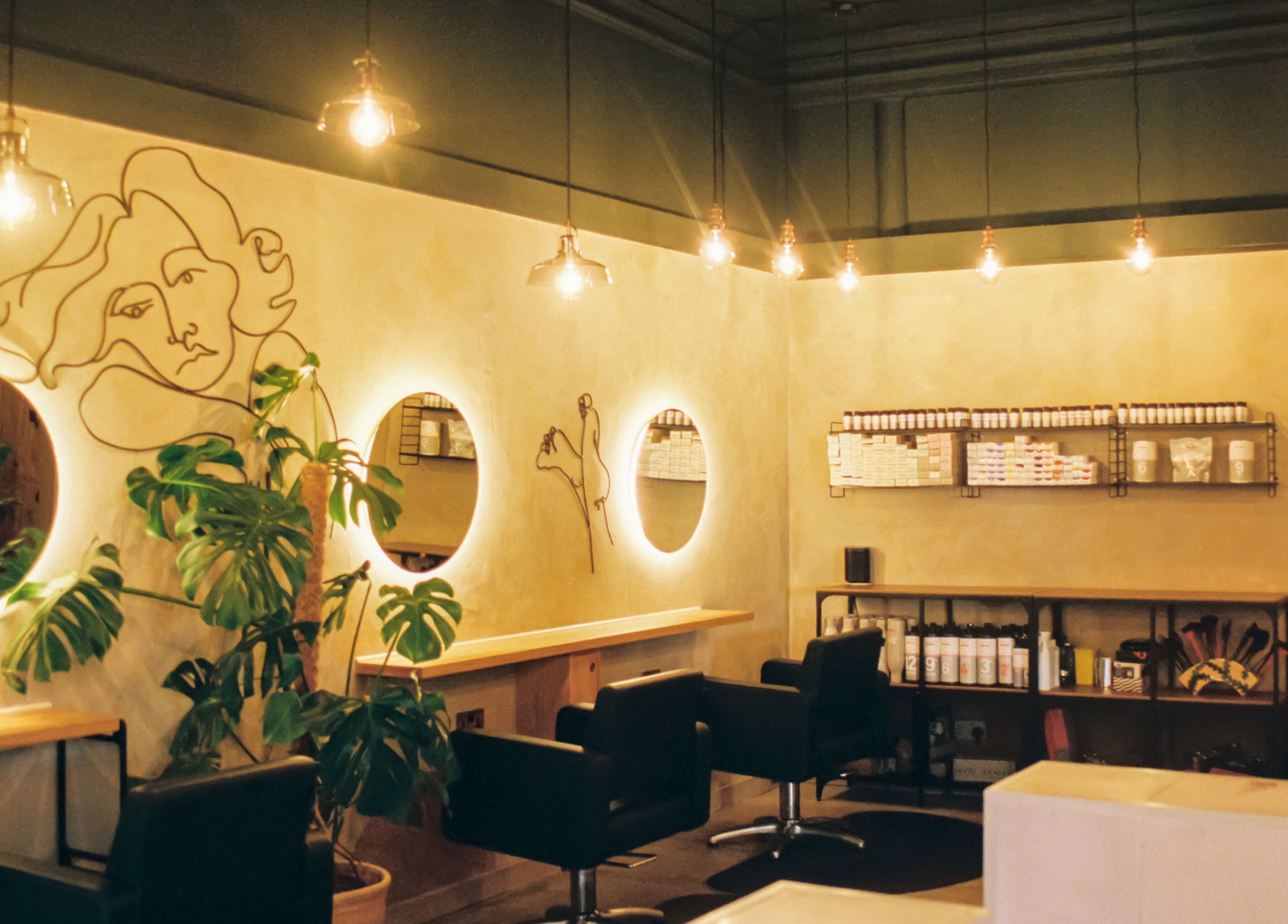 Stylish salon interior with illuminated mirrors at Cùrlach, Glasgow, Scotland, GB.
