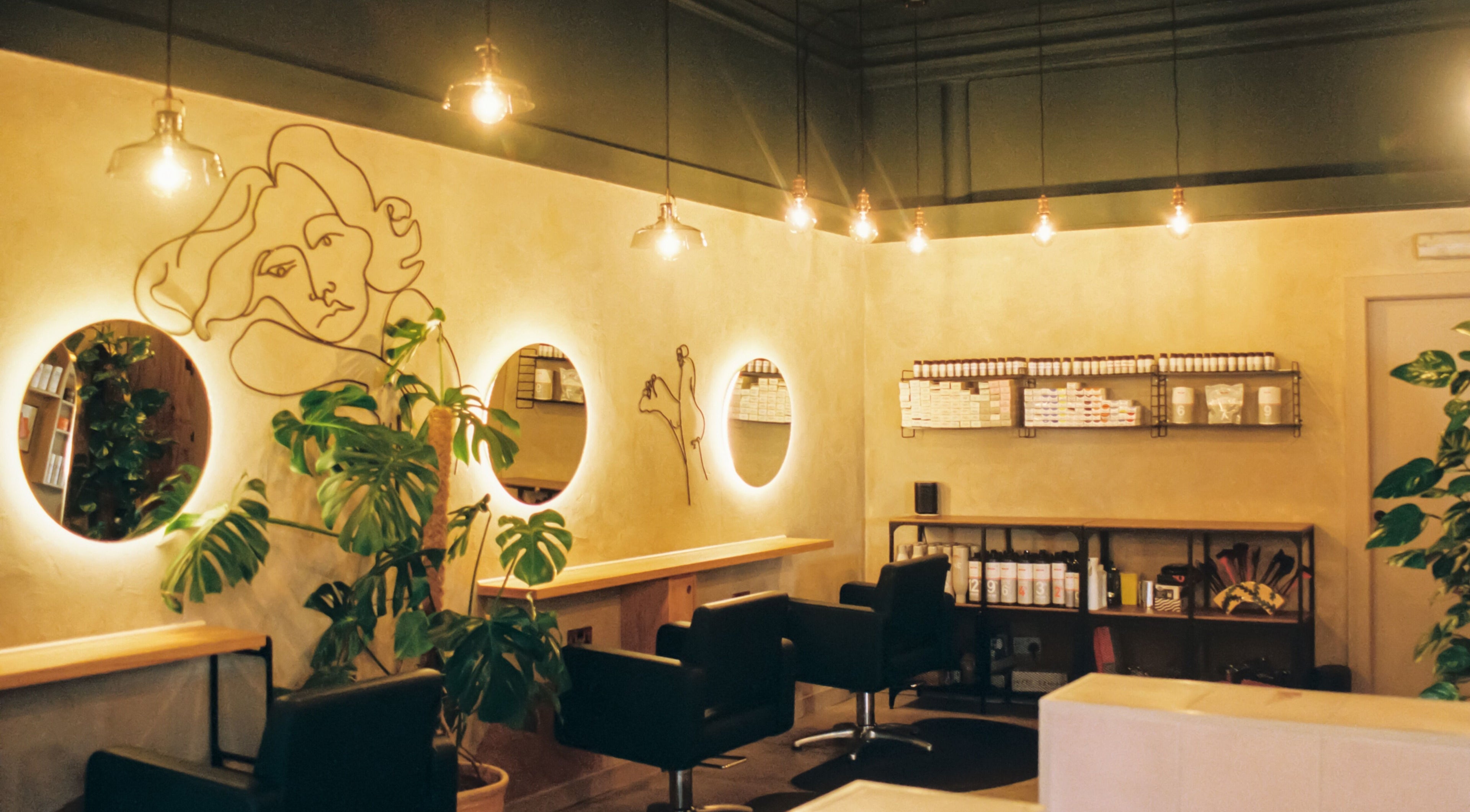 Stylish salon interior with illuminated mirrors at Cùrlach, Glasgow, Scotland, GB.