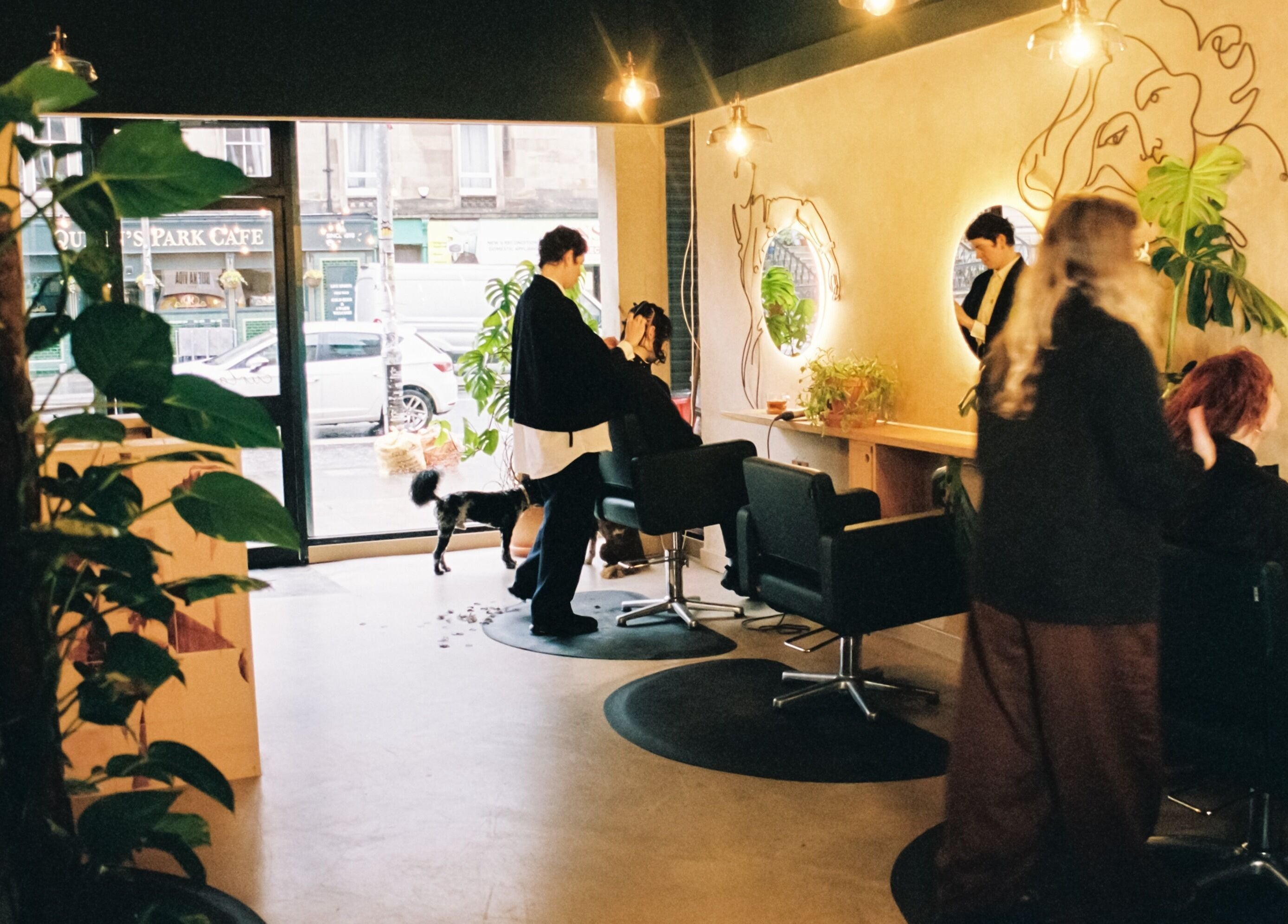 Chic salon interior at Cùrlach, Glasgow, Scotland, GB, with stylish decor and hair treatments in progress.