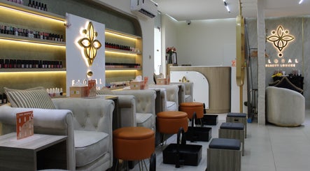 Relaxing nail salon area at Floral Beauty Lounge in Abu Dhabi, AE, featuring plush seating and nail polish displays.
