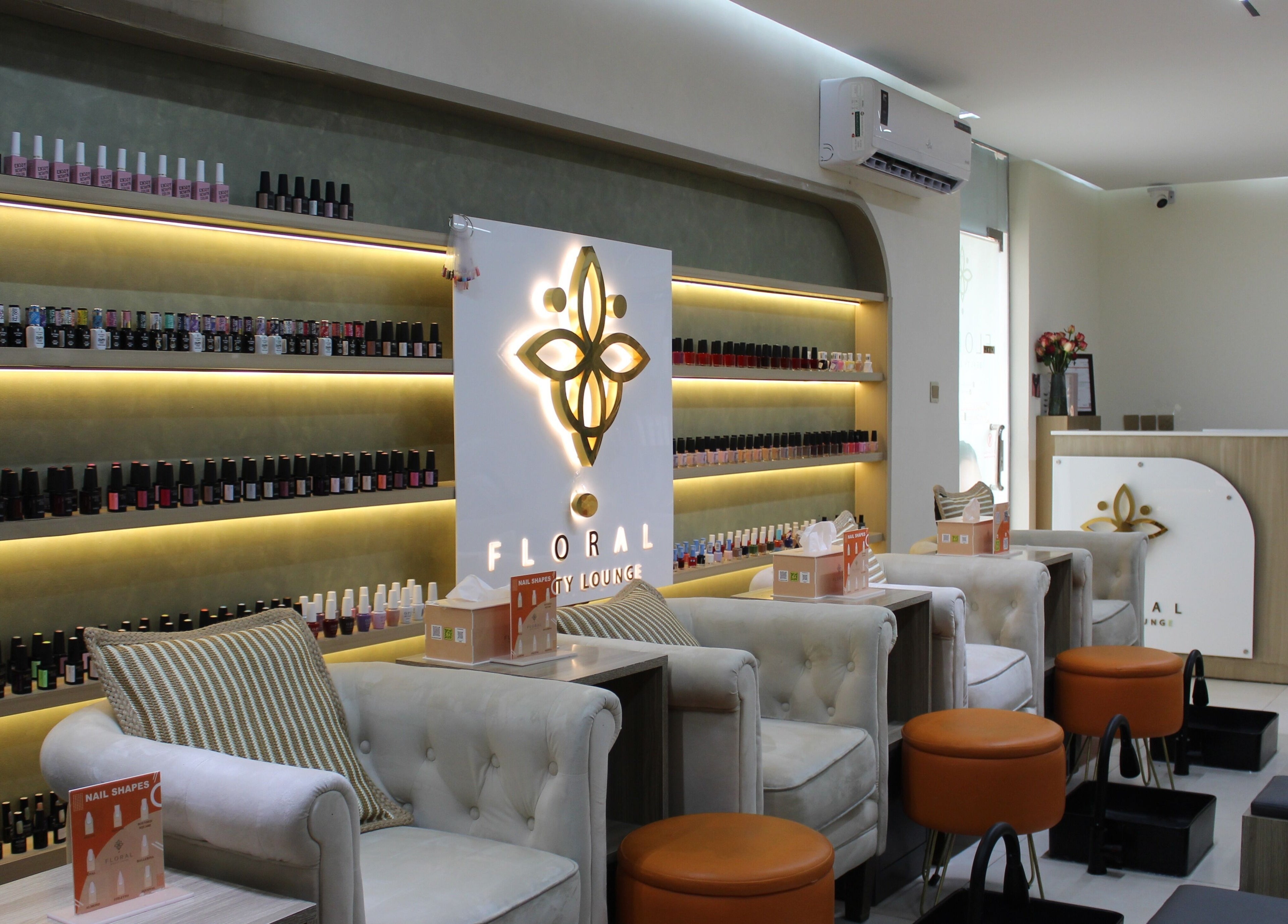 Luxurious interior of Floral Beauty Lounge in Abu Dhabi, AE showcasing elegant nail salon seating and displays.