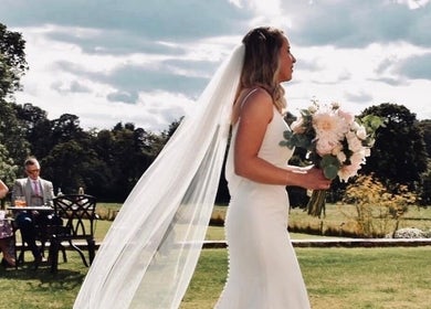 Bride with bouquet at outdoor wedding venue, Get Sprayed, Exeter, England, GB.
