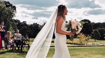 Bride with bouquet at outdoor wedding venue, Get Sprayed, Exeter, England, GB.