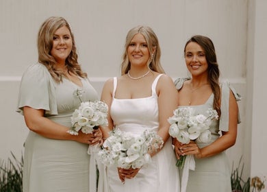 Bridesmaids and bride in elegant dresses holding bouquets at Get Sprayed, Exeter, England, GB.