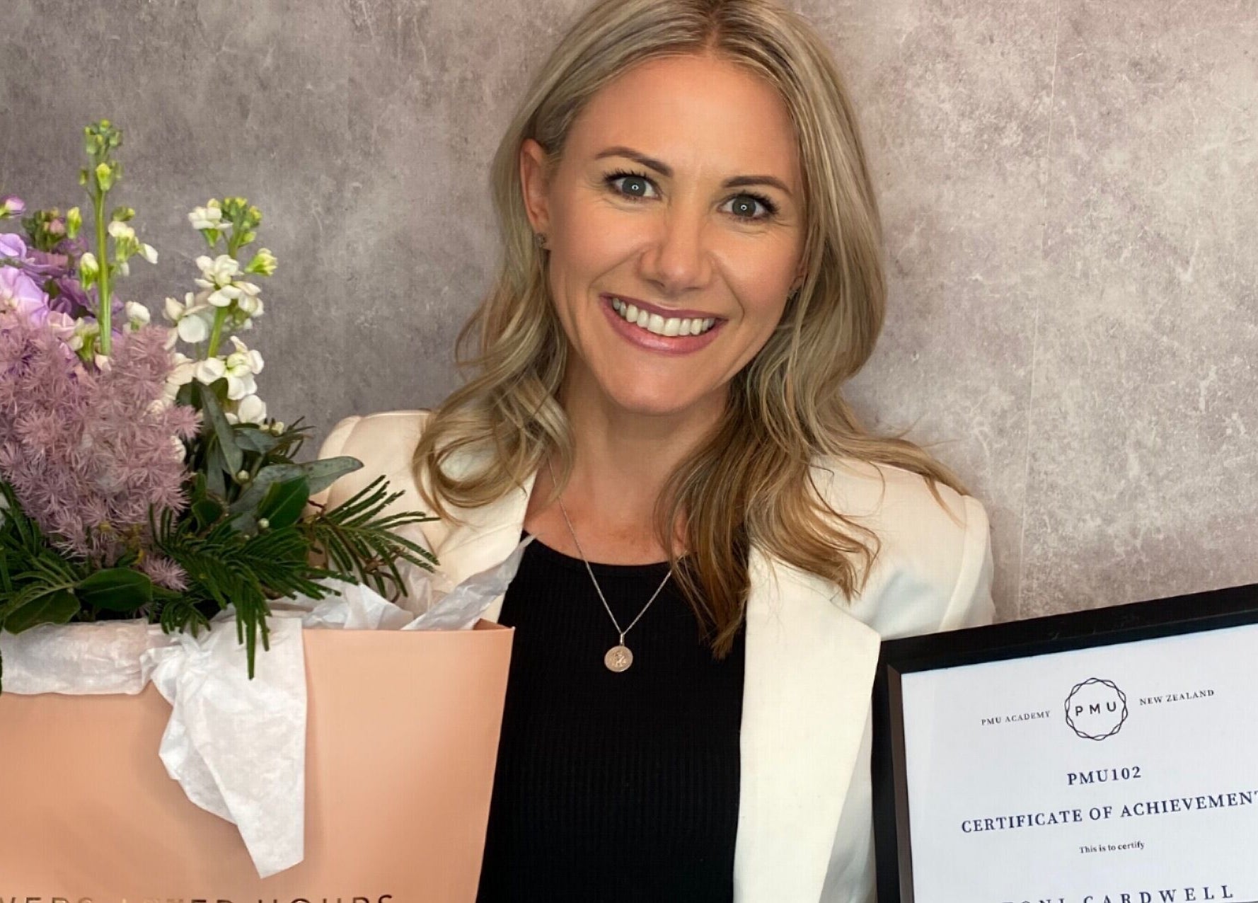 Award-winning staff at Tonic Beauté, Auckland, Auckland, NZ, holding flowers and a certificate.