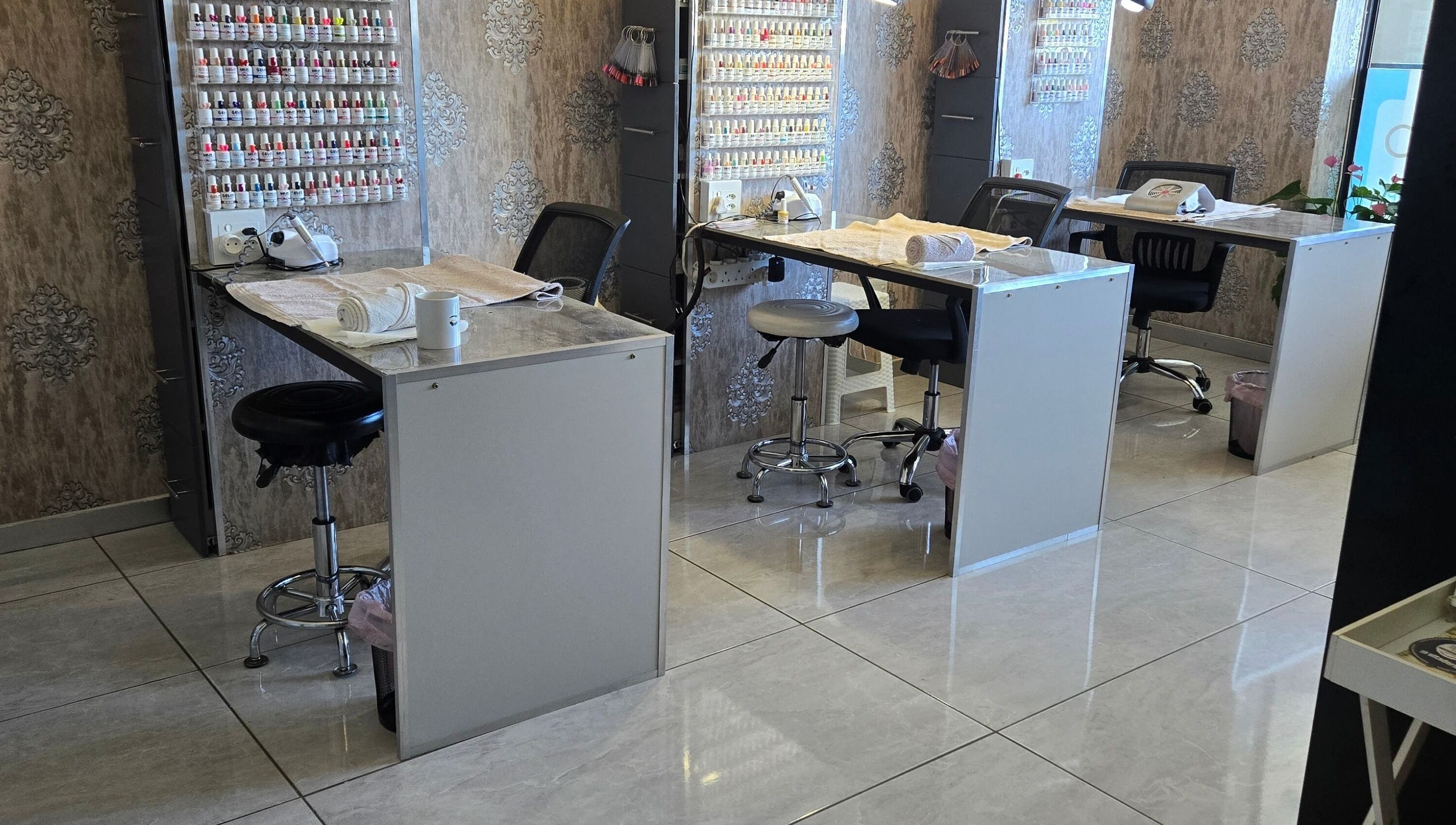 Modern nail salon at I Lipo Lab Modimall, Modimolle, Limpopo, ZA with elegant workstations and nail polish display.
