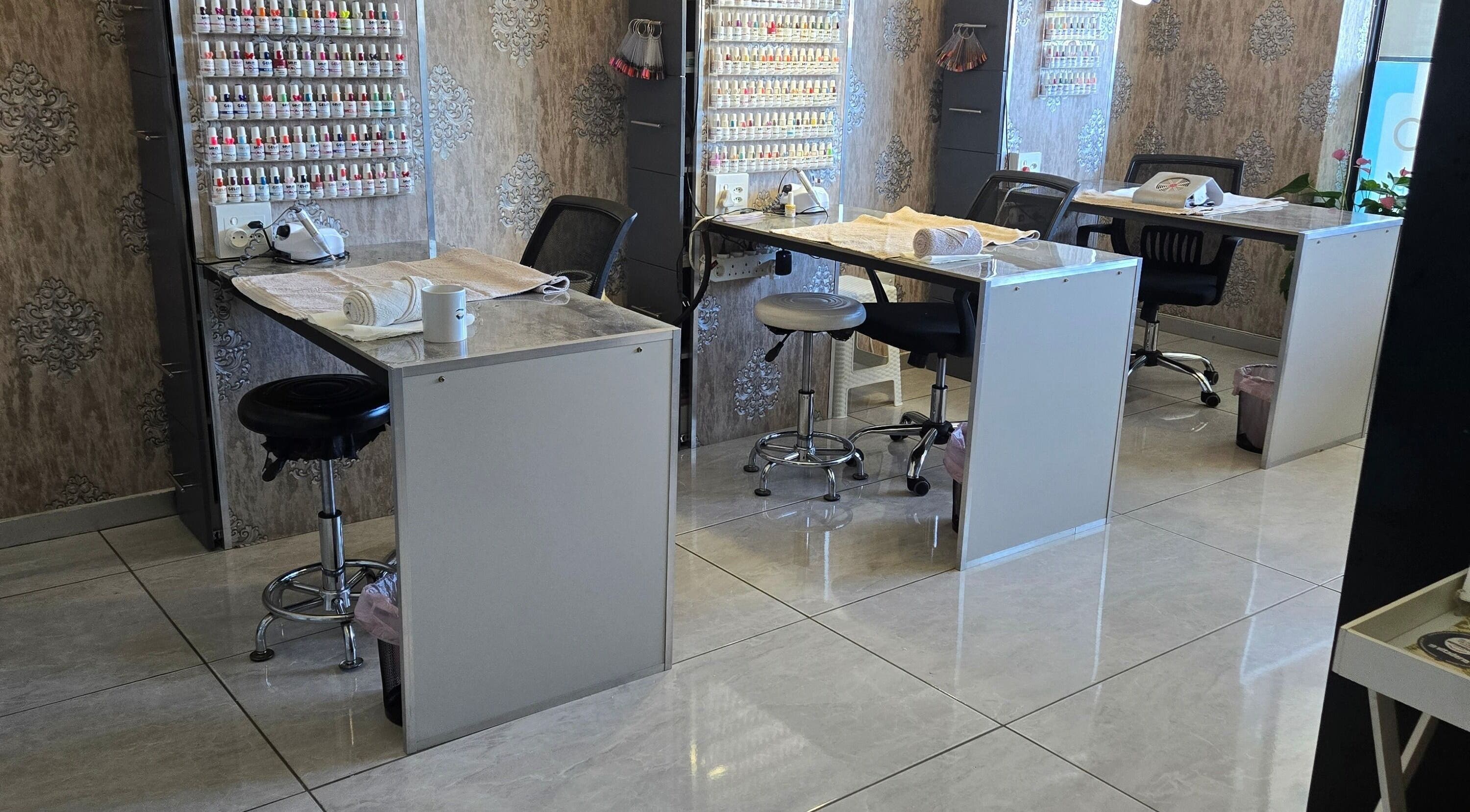 Modern nail salon at I Lipo Lab Modimall, Modimolle, Limpopo, ZA with elegant workstations and nail polish display.