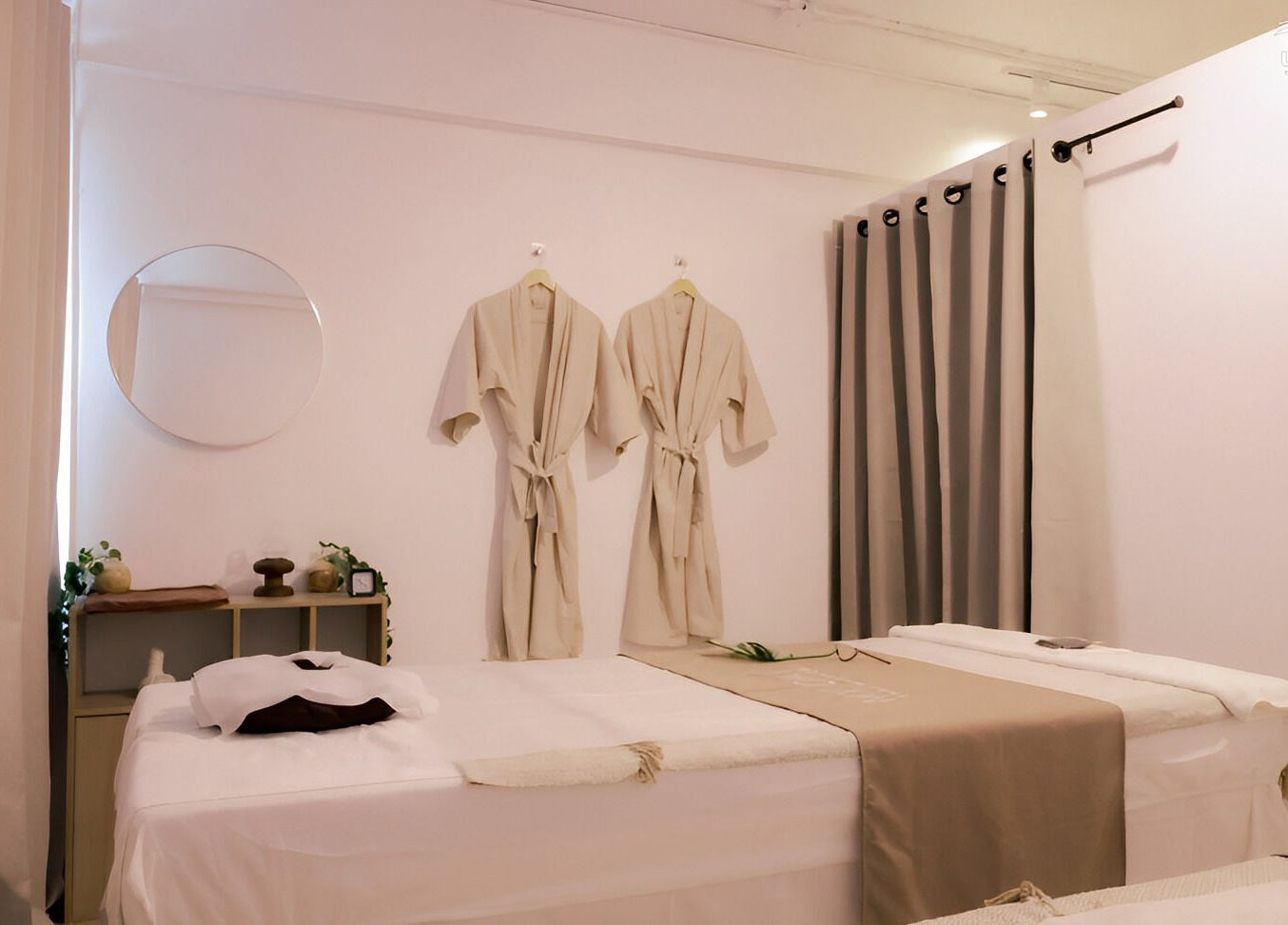 Calm massage room at My Day Thai Massage in Krung Thep Maha Nakhon, featuring elegant robes and a mirror.