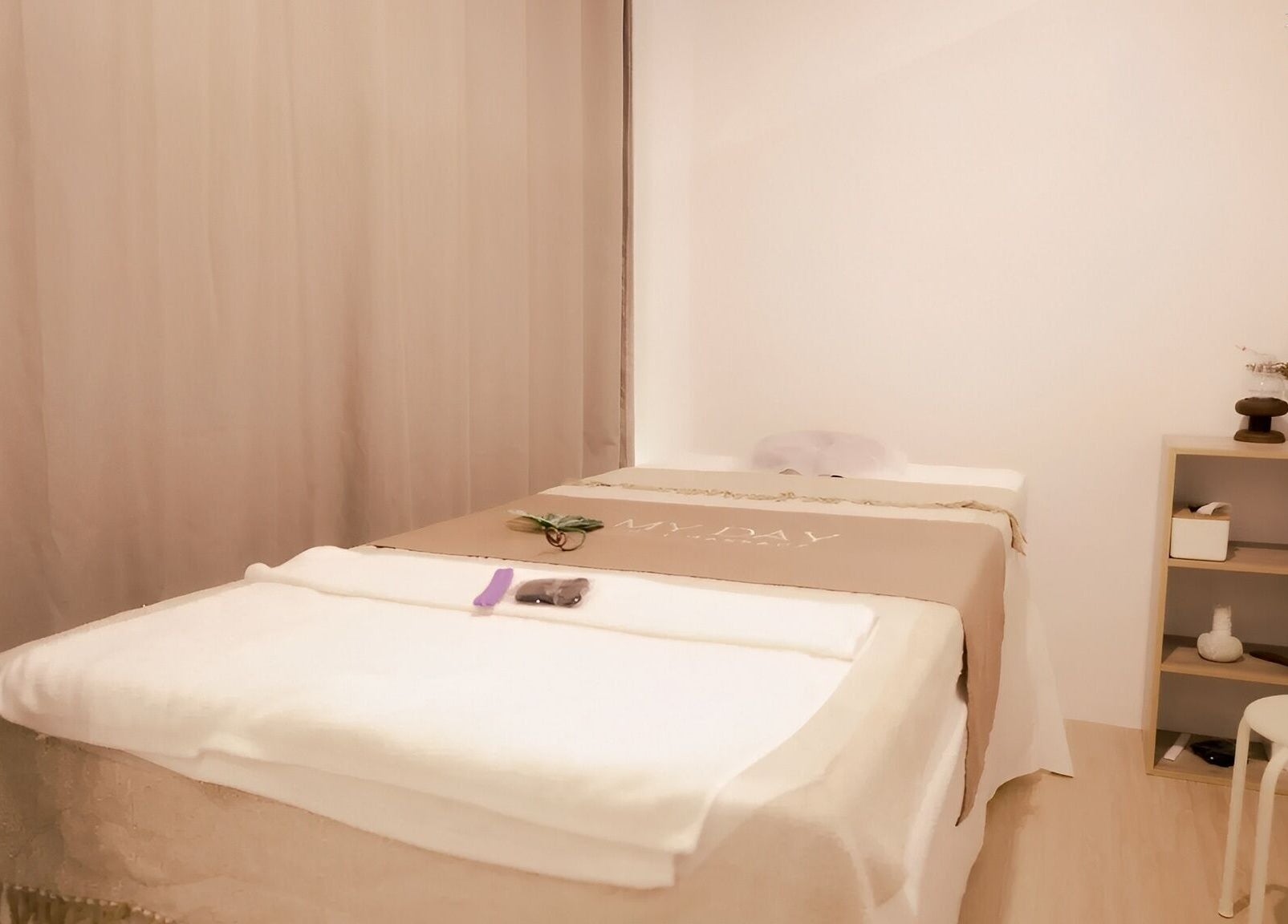 Cozy massage room at My Day Thai Massage, Krung Thep Maha Nakhon, featuring a neatly arranged bed.