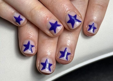 Blue star nail art at The Studio Nail Box, Cardiff, Wales, GB. Perfect for creative manicures.