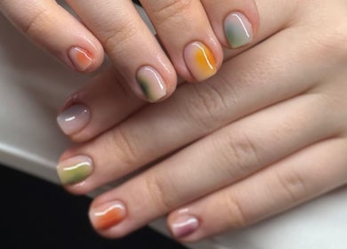 Colorful fall-themed manicure at The Studio Nail Box, Cardiff, Wales, GB showcasing artistic nail designs.