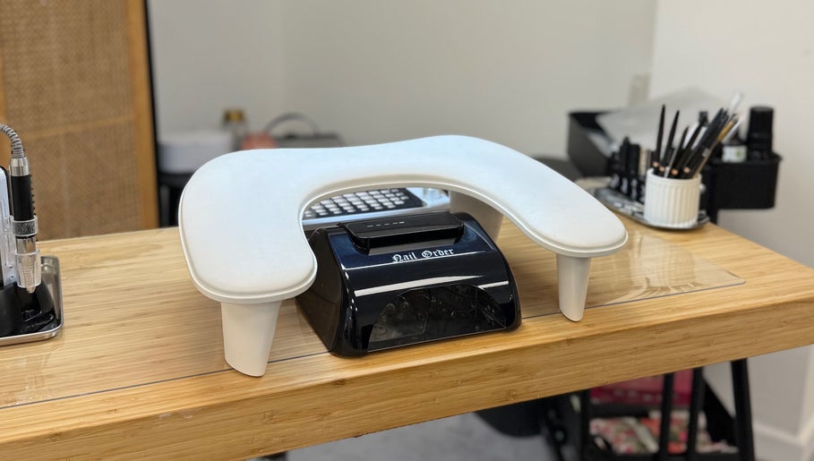 Modern nail station at The Studio Nail Box, Cardiff, Wales, GB, featuring sleek tools and lamp.