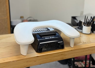 Modern nail station at The Studio Nail Box, Cardiff, Wales, GB, featuring sleek tools and lamp.