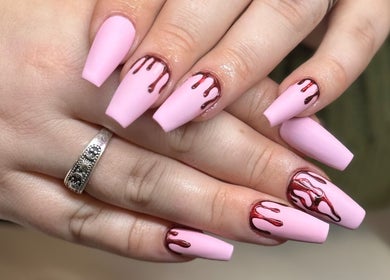 Unique pink nails with artistic red drip design at The Studio Nail Box, Cardiff, Wales, GB.