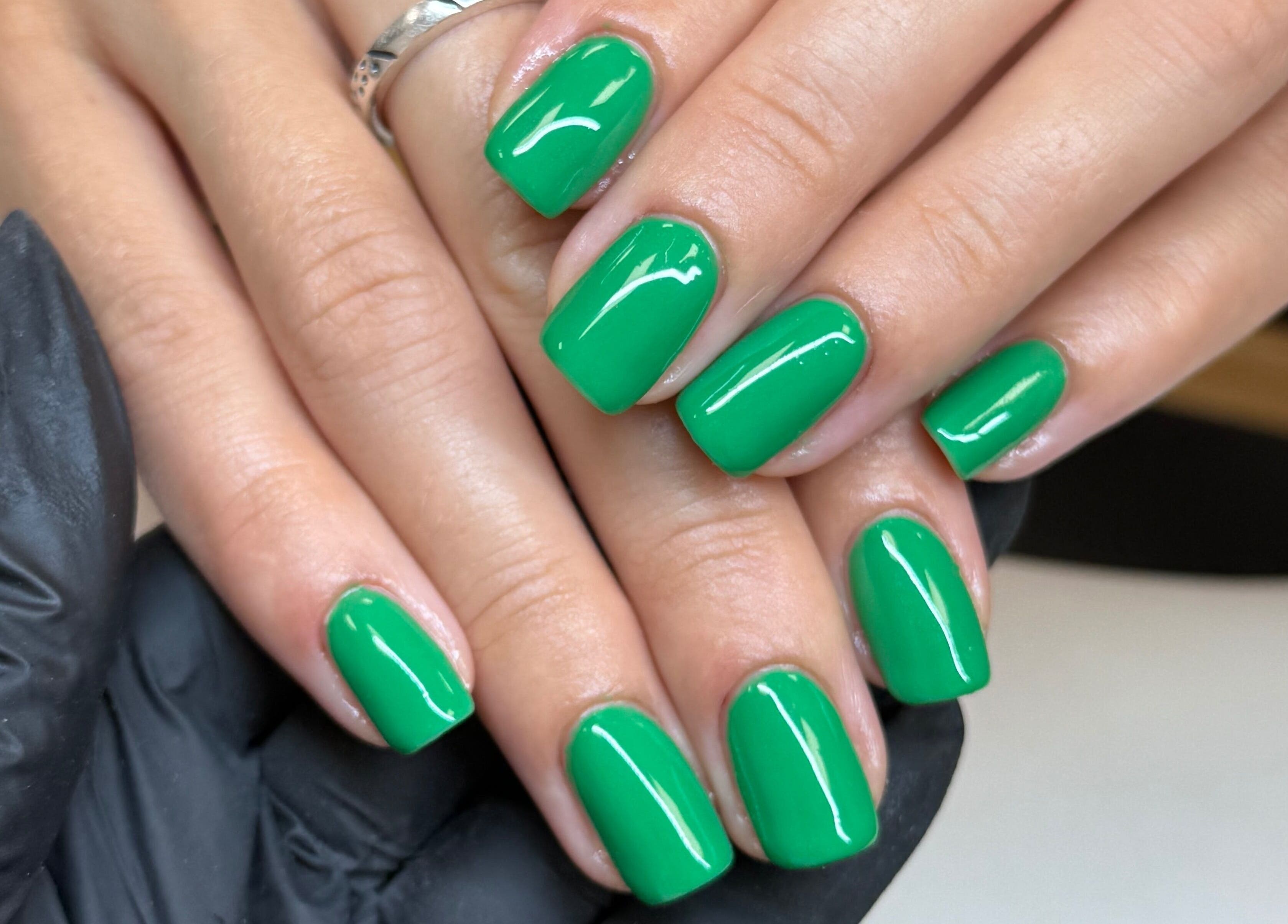 Vibrant green nails polished at The Studio Nail Box, Cardiff, Wales, GB.