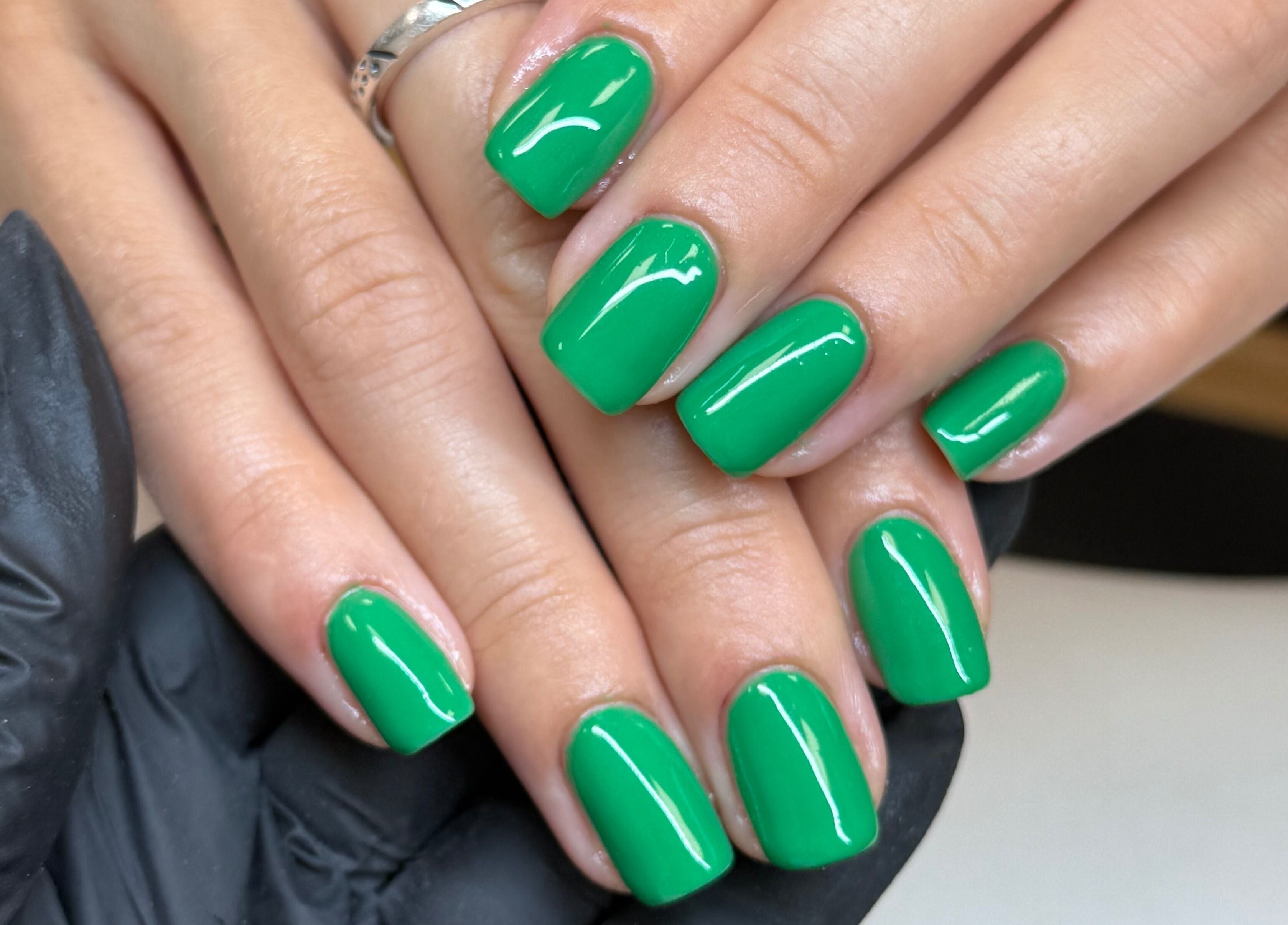 Vibrant green nails polished at The Studio Nail Box, Cardiff, Wales, GB.