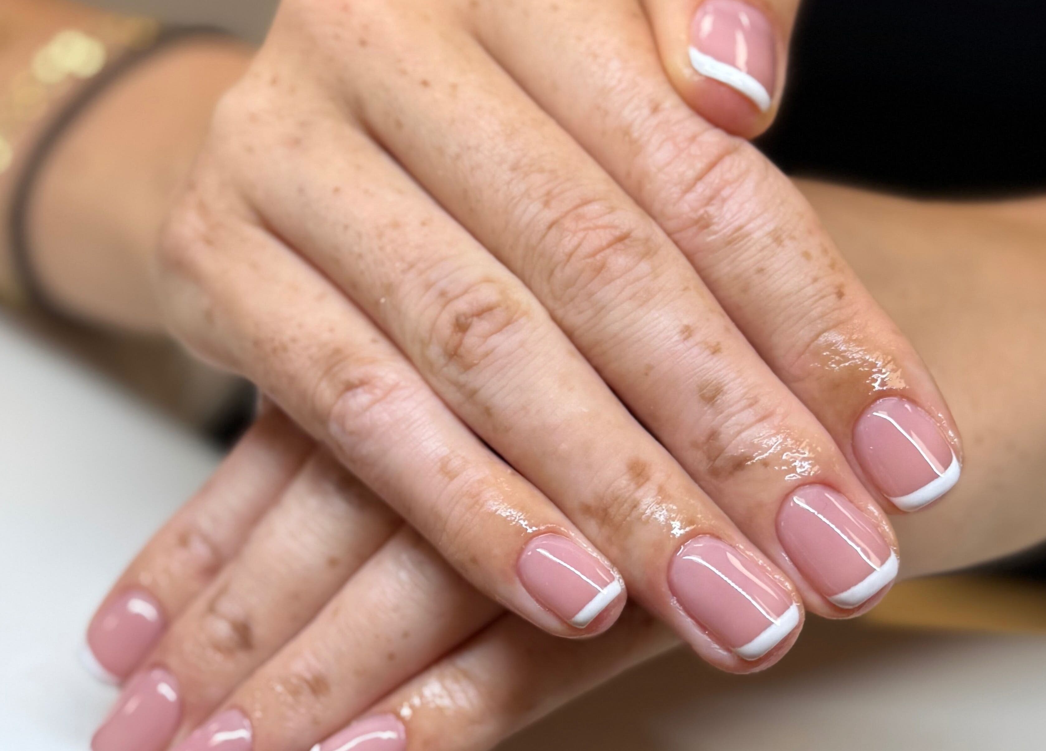 Elegant French manicure at The Studio Nail Box, Cardiff, Wales, GB showcasing neat pink and white nails.