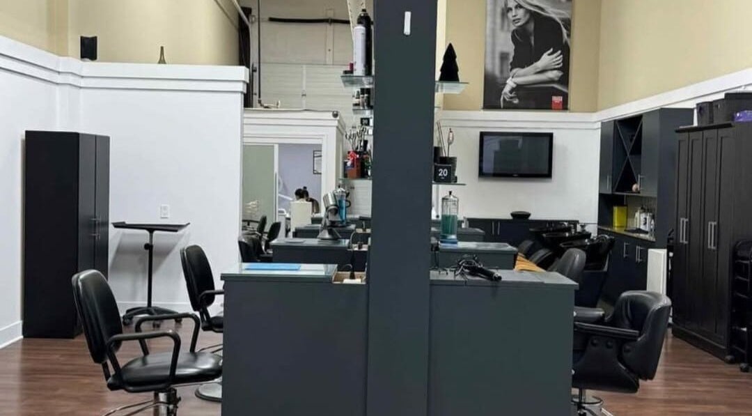 Modern interior of Manestream Salon in Toronto, Ontario, CA with sleek styling stations and black chairs.