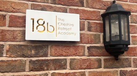 Elegant sign of The Cheshire Retreat Academy Ltd on a brick wall in Hale, England, GB.