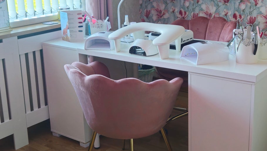 Elegant nail station at O'Nails, Newry, Northern Ireland, GB with plush pink chairs and manicure equipment.