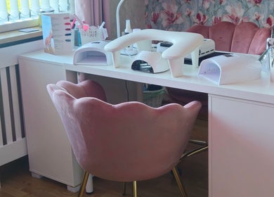 Elegant nail station at O'Nails, Newry, Northern Ireland, GB with plush pink chairs and manicure equipment.
