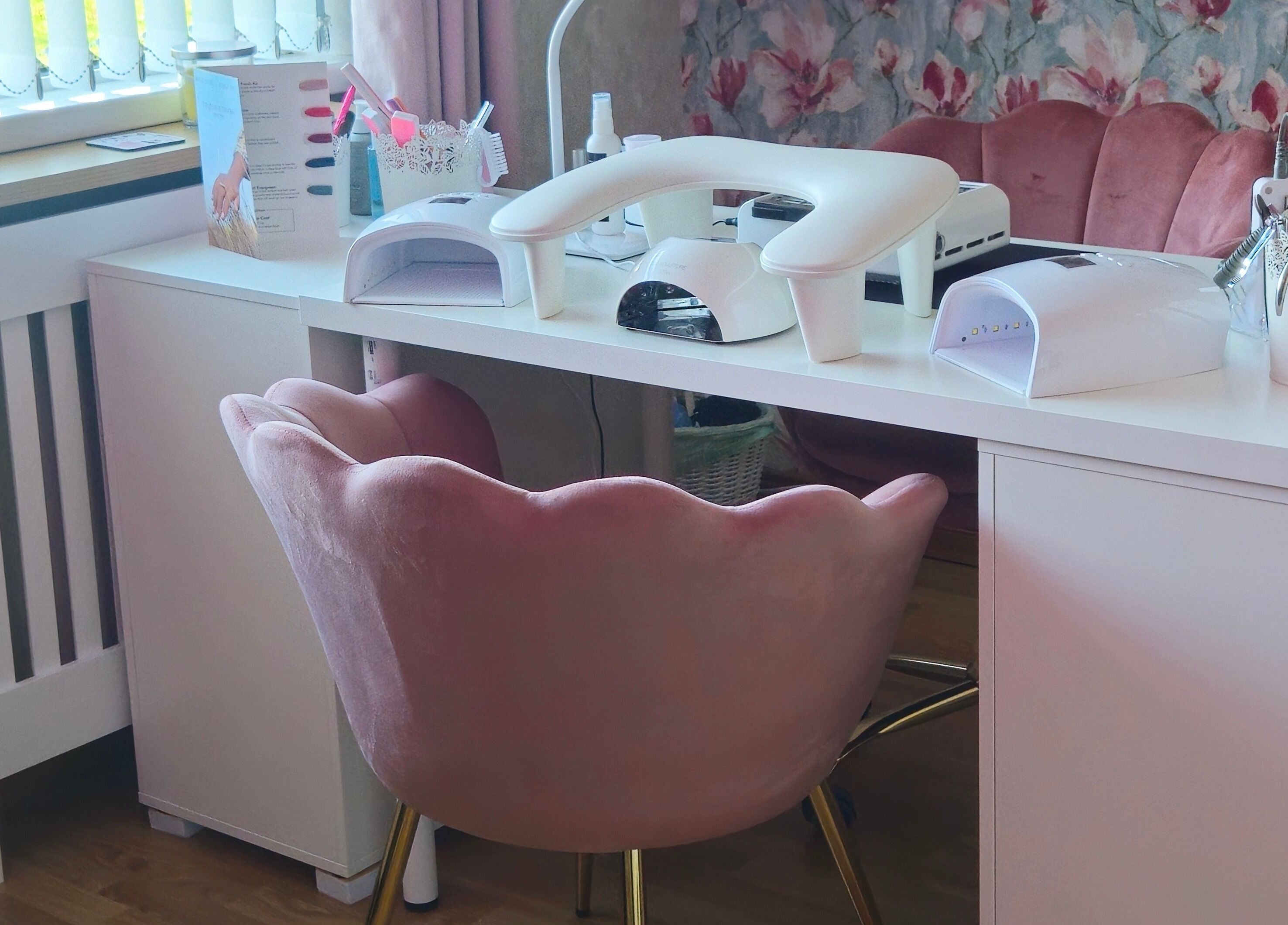 Elegant nail station at O'Nails, Newry, Northern Ireland, GB with plush pink chairs and manicure equipment.