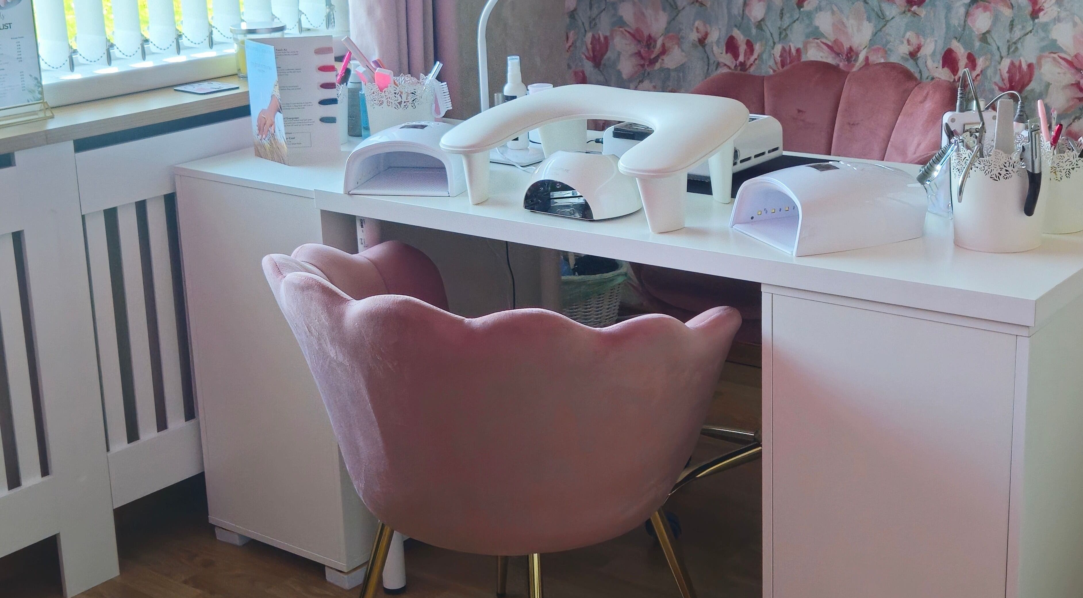 Elegant nail station at O'Nails, Newry, Northern Ireland, GB with plush pink chairs and manicure equipment.